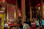 Chiang Mai - The Wat Phra Singh temple. The small Viharn Lai Kham (Gilded Hall), the interiors are  decorated with brocade-like gold and red pattern. 